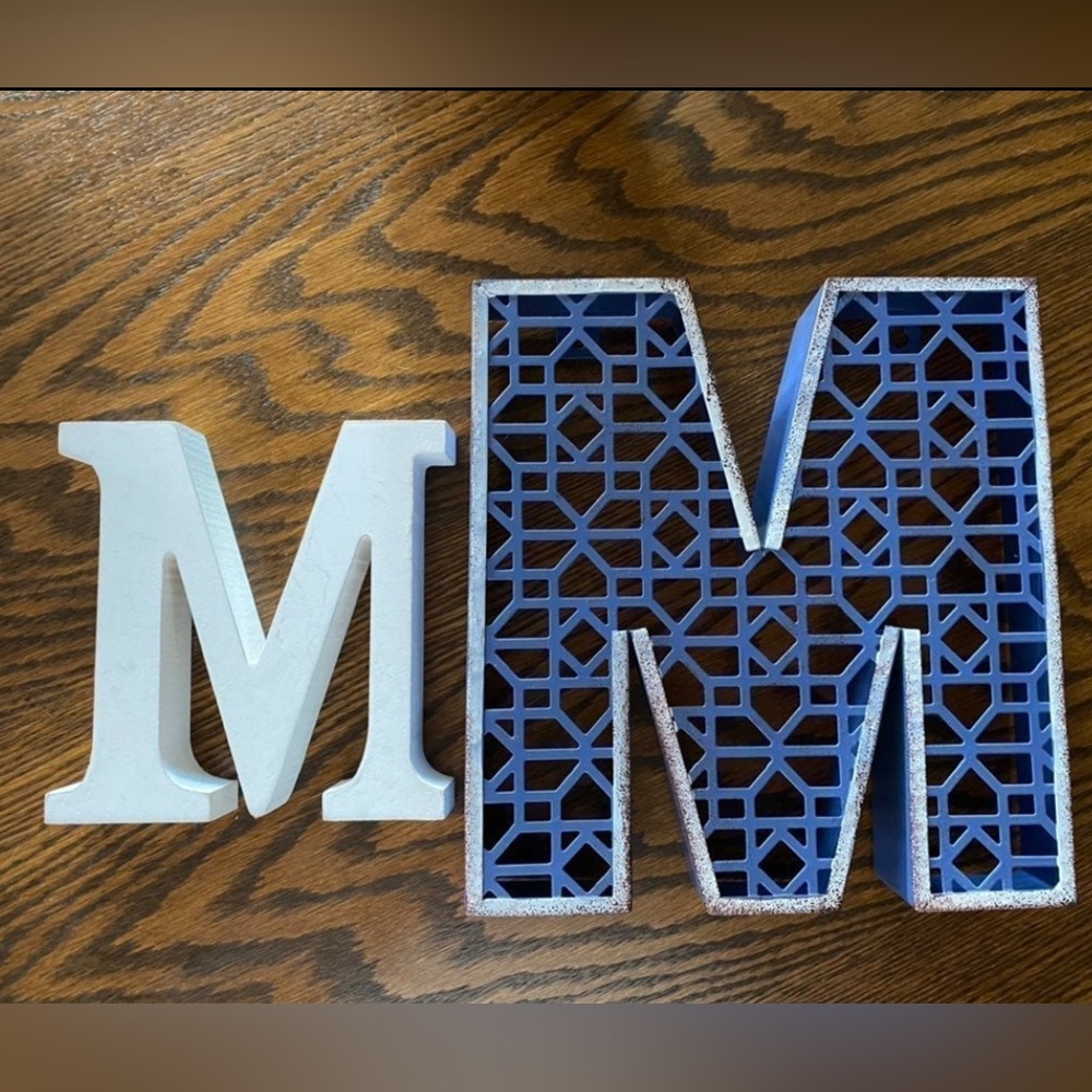 Two "M" signs one wood one metal